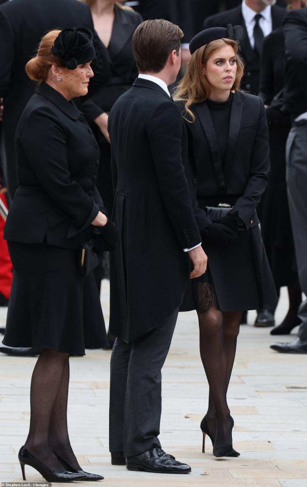 62561221-11224681-Princesses_Beatrice_and_Eugenie_looked_earnest_today_alongside_S-m-2_1663580840114